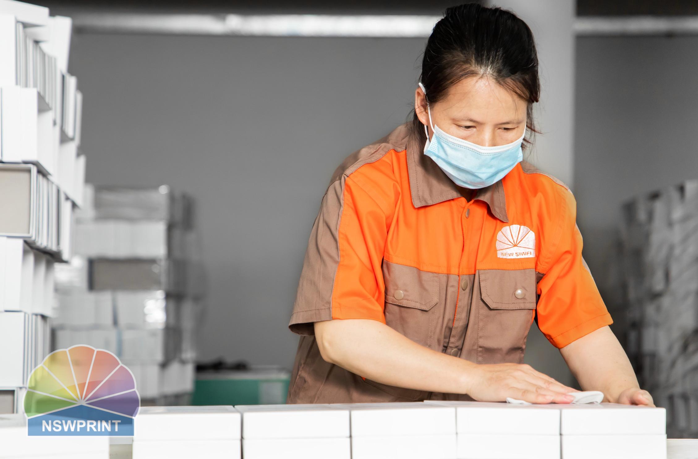 Quality control inspector checking finished paper packaging